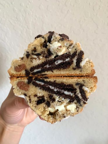 Soft baked milk and white chocolate chip cookie with Oreo pieces, stuffed with an Oreo cookie