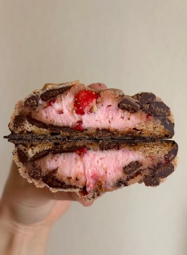 Strawberry stuffed cookie with semi-sweet and dark chocolate chips, dipped in chocolate base
