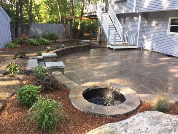 Custom Curved Patio With Wall and elevated Fire Pit