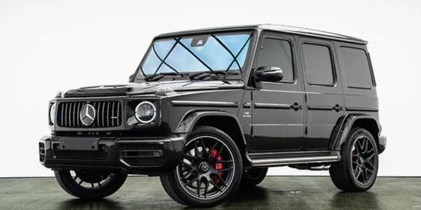 Black Mercedes G-Class SUV with stylish black rims and red brake calipers.