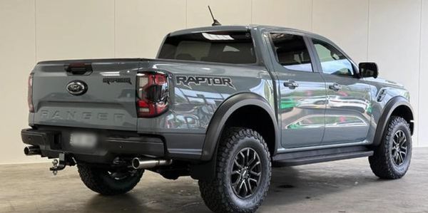 Gray Ford Ranger Raptor pickup truck in a showroom.