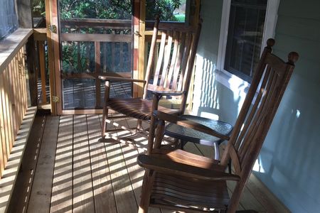Screened porch and rocking chairs at The Old Campbell Farm