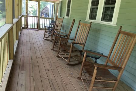 Screened porch and rocking chairs at The Dock Barnard Farm