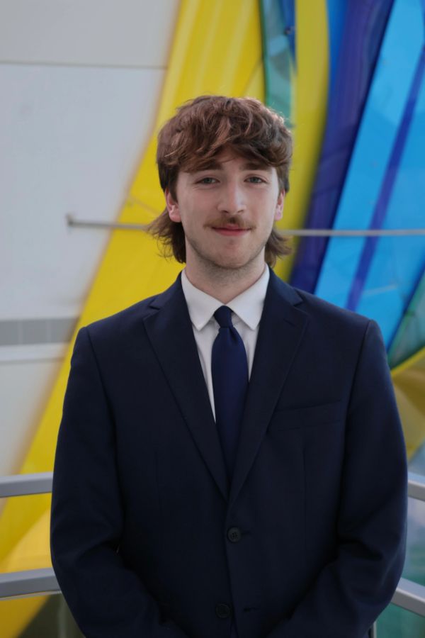 Young man in a suit with colorful background.