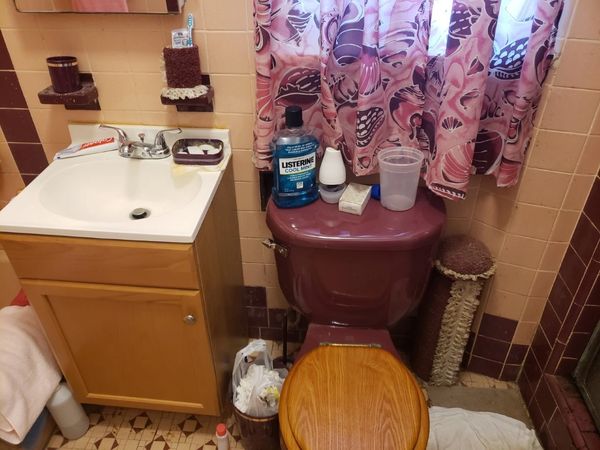 toilet with cupboard and bathroom stuff on it