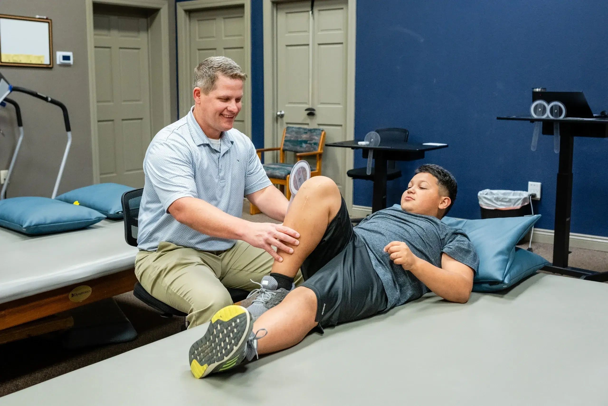 a physical therapist checking a patient  