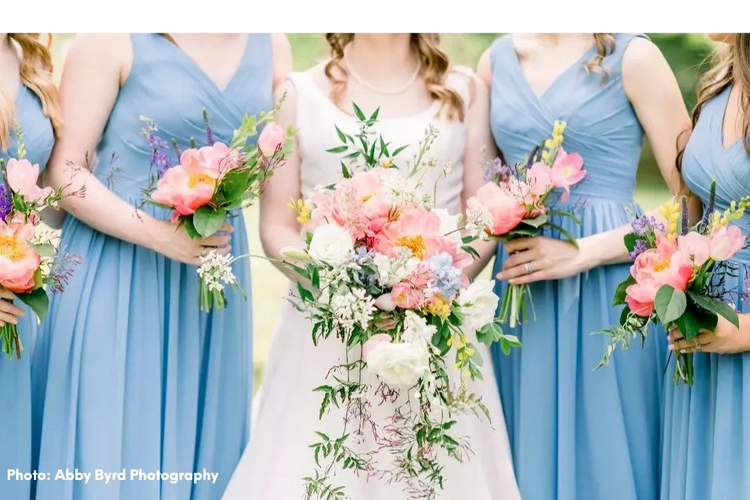 Bride and bridesmaids holding flowers 