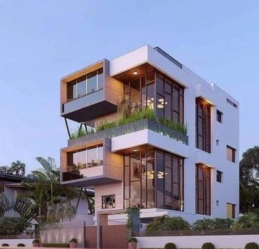 Modern three-story house with large glass windows and greenery on balconies.