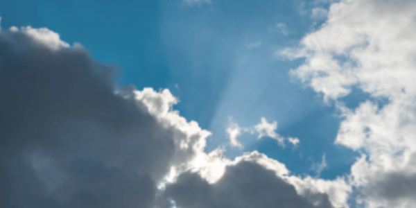 sky with shifting clouds and emerging light, symbolizing transition, patience, and listening to the