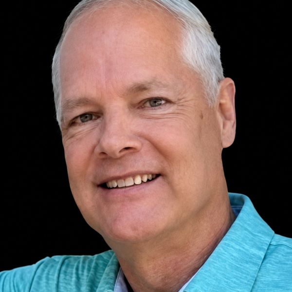 Smiling middle-aged man with gray hair.
