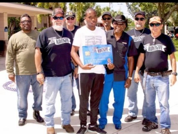 A Man holding up a check