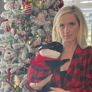 Bunny and blonde girl in front of Christmas tree