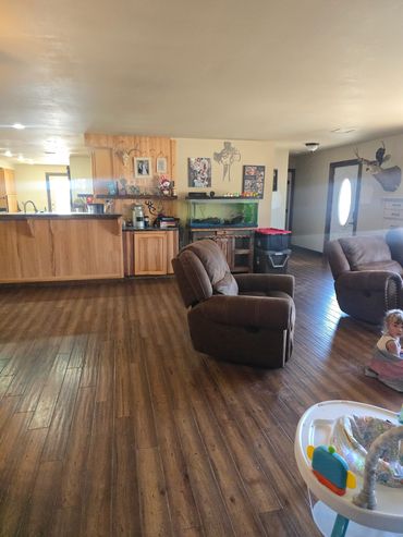 Cozy living room with brown recliners and wooden floor.