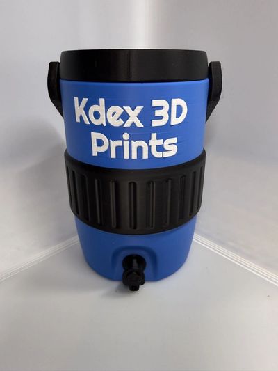 Blue beverage dispenser labeled 'Kdex 3D Prints' with a black handle and spout.