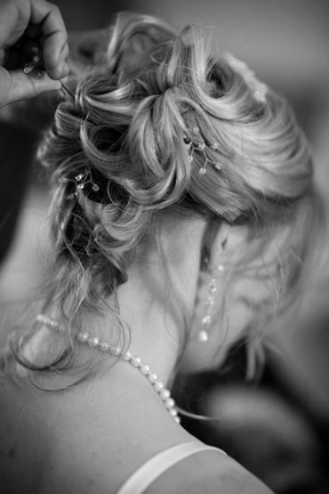 Woman's elegant updo hairstyle being adjusted.