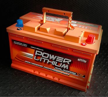 Orange Power Lithium battery with dual purpose and motorsport branding.