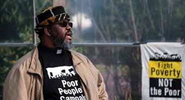 Man wearing a shirt advocating for the Poor People's Campaign.