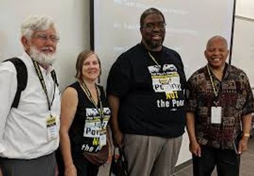 Four people smiling at a conference or event.
