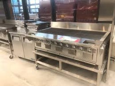 Full view of flat top kitchen grille in commercial kitchen