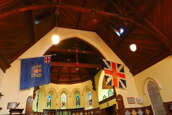 union jack and a blue flag inside the cathedral