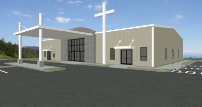 Modern church building with a large white cross and covered entrance.