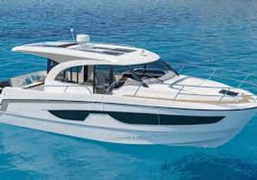 Modern white yacht cruising on clear blue water under bright sunlight.