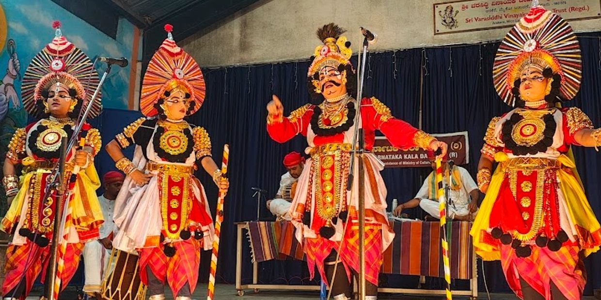 Performers in vibrant traditional costumes during a cultural dance event.