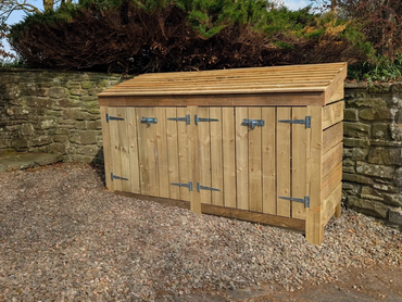 Wooden outdoor storage shed with multiple doors and metal hinges.