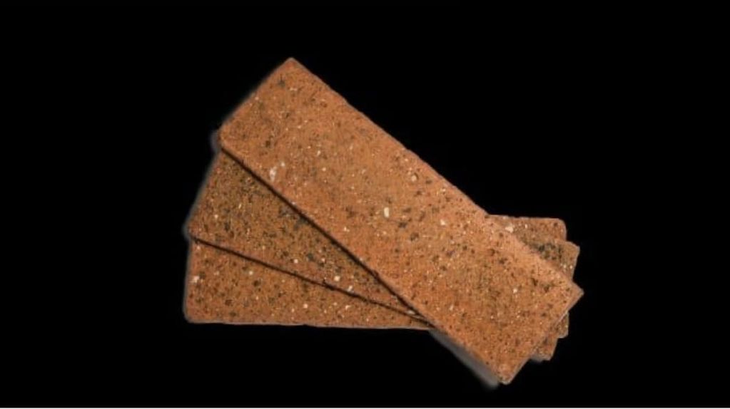 Three rectangular brown crispbread crackers on a black background.
