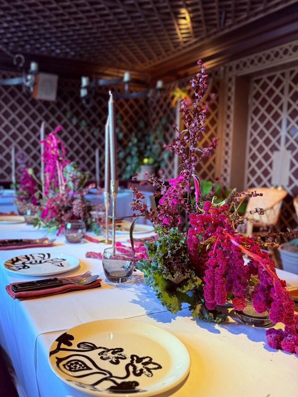 Elegant table setting with floral arrangements and unique plates.
