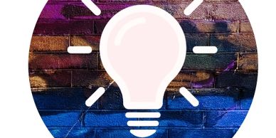 Light bulb icon on a colorful brick wall background.