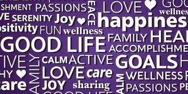 Wall art with positive words like happiness, love, family, and goals in white on a purple and blue brick background.