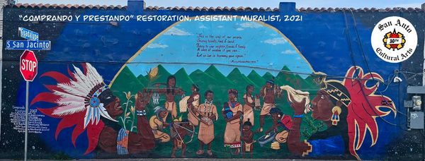 Colorful mural showing indigenous people and cultural heritage on a city wall.