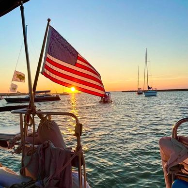 American flag on a boat at sunset.