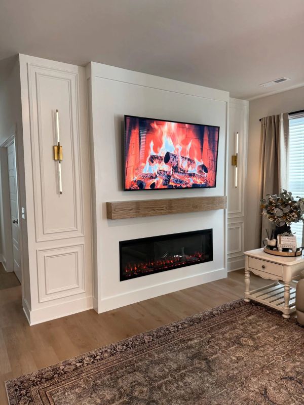 Modern living room with electric fireplace and TV showing fireplace video.