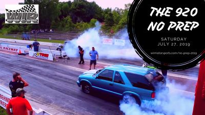 A blue car performs a burnout at a drag race event called The 920 No Prep.