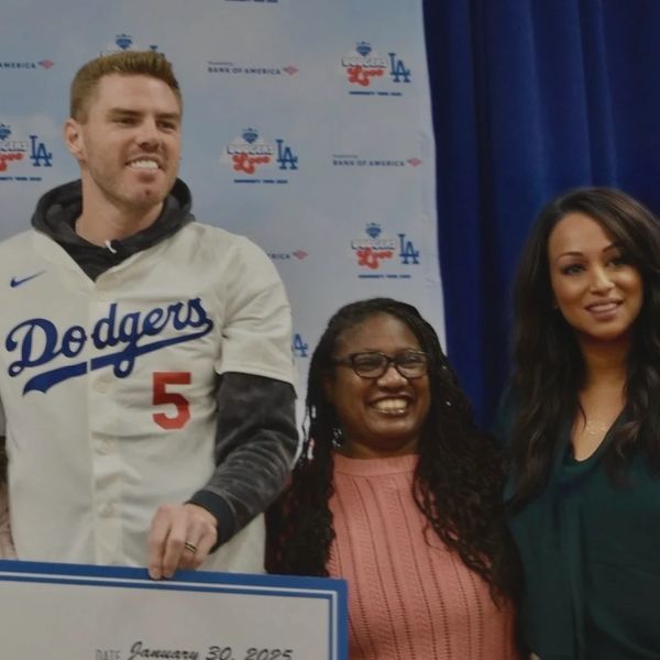 Man in Dodgers jersey with two women smiling.