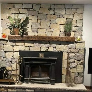 Natural Stone fireplace with a hand hewn mantel 
