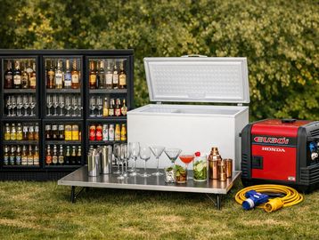 Outdoor bar setup with drinks, glasses, cooler, and a Honda generator.