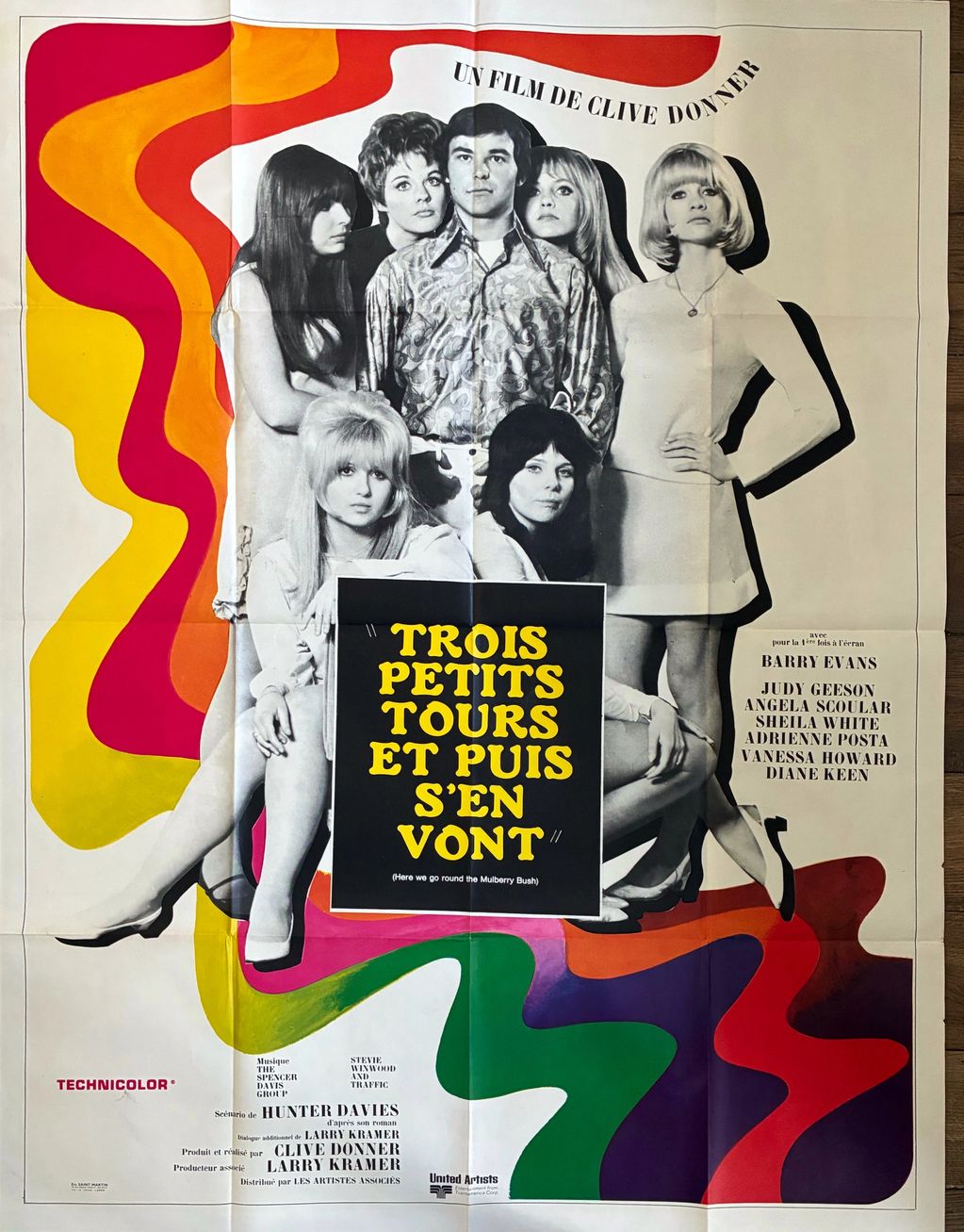 A man standing with a group of women, with the title "Trois Petits Tours Et Puis S'en Vont