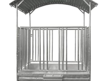 Metal animal shelter or pen with roof.