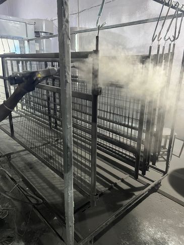 Industrial spray painting in progress.