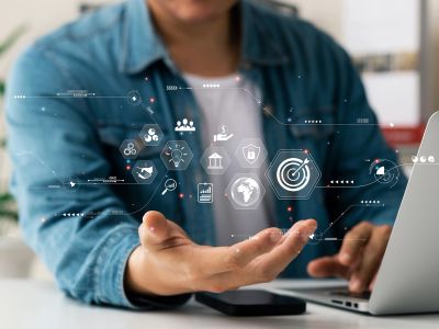 Businessman interacting with futuristic digital interface icons.