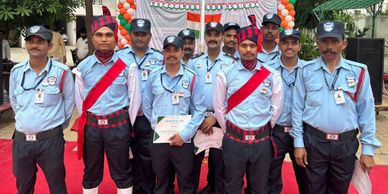 Group of security guards posing on Independence Day with certificates and decorations.