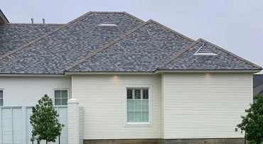 Brand-new shingled roof providing weather protection for a home