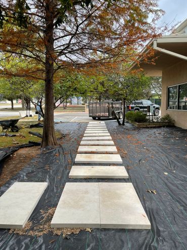 The before look of a limestone paver pathway before we added river rock in Brodie Ln Austin