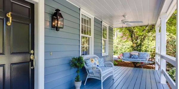 cane sofa on verandah of weatherboard home