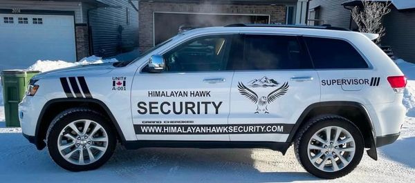 White security SUV with Himalayan Hawk branding parked in a snowy residential area.
