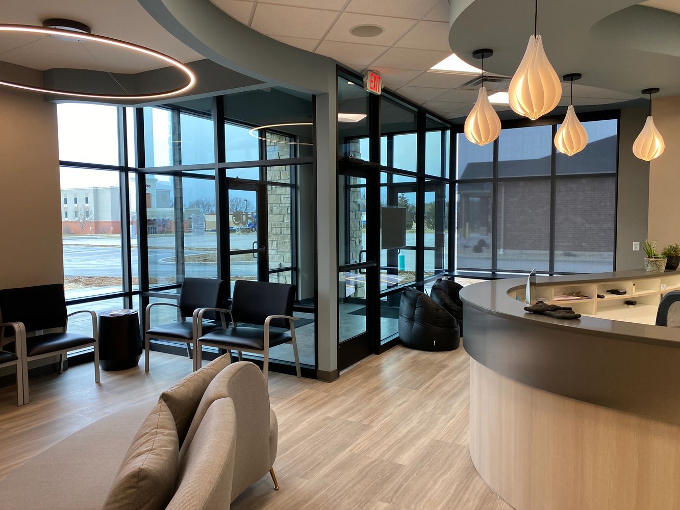 Modern office lobby with stylish seating and pendant lighting.