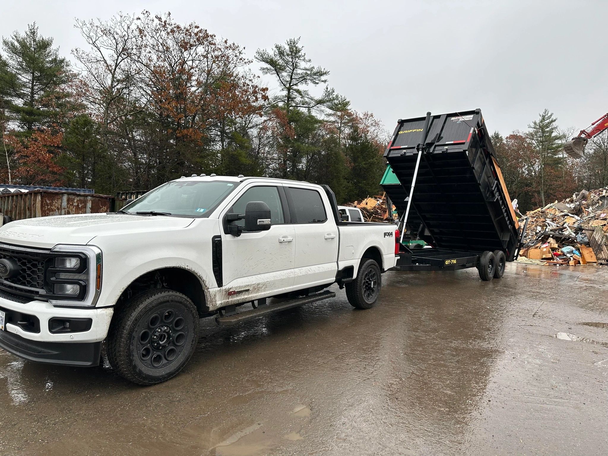 Stack of books next to pencils in a holder and a camera.